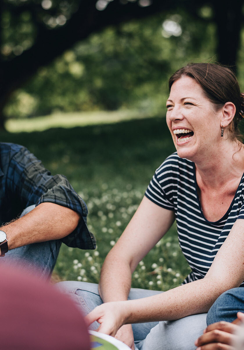 Cheerful woman in the park with her friends